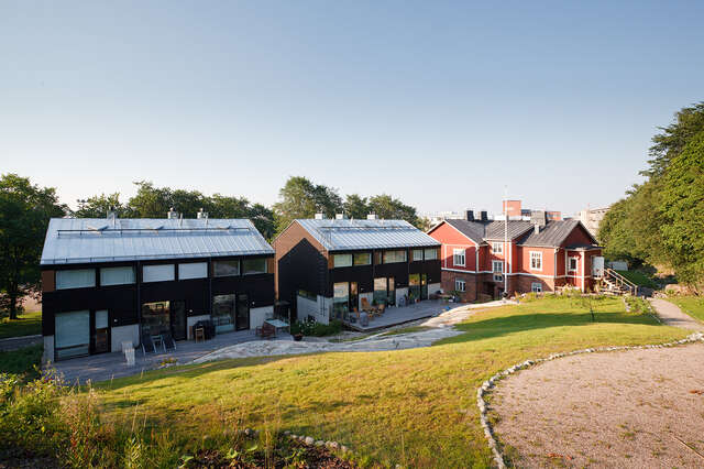 Three houses made from multiple materials and with different styles.