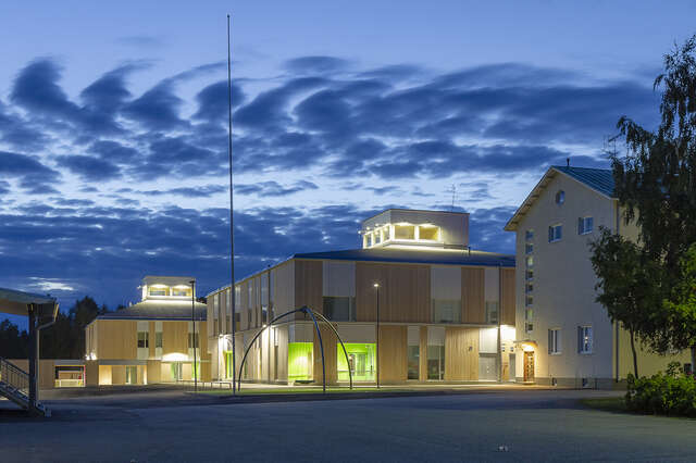 School facade illuminated during the evening.