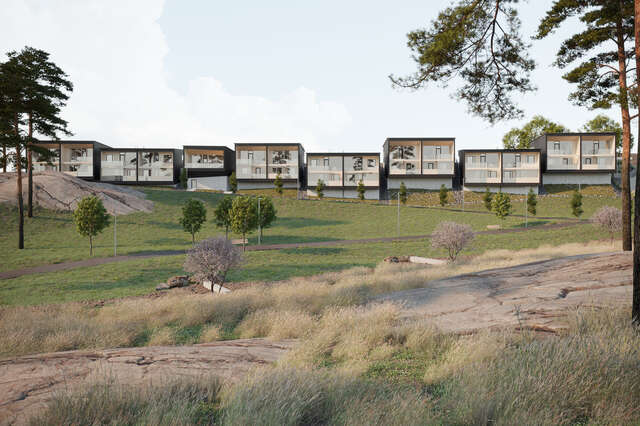 Row of wooden houses with grass hill in front.