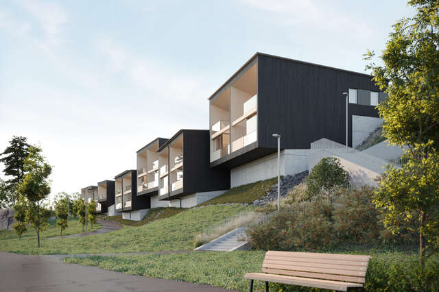 Row of wooden detached houses with park bench in foreground.