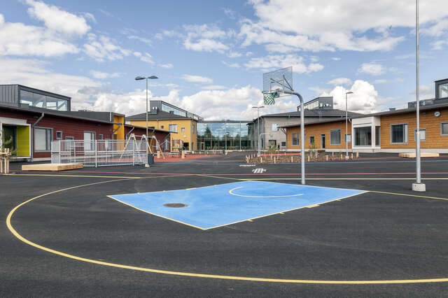 School yard with a basketball basket and the playing areas.
