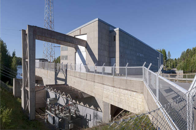 Power plant with pent roof and facade of light-shaded stone.