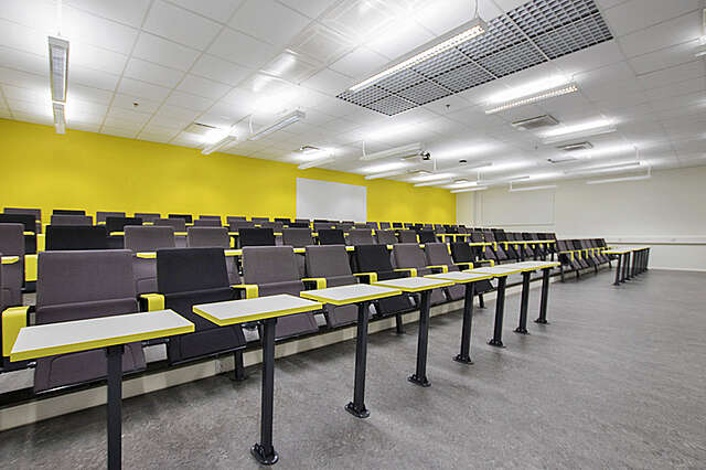 lecture hall with yellow details.
