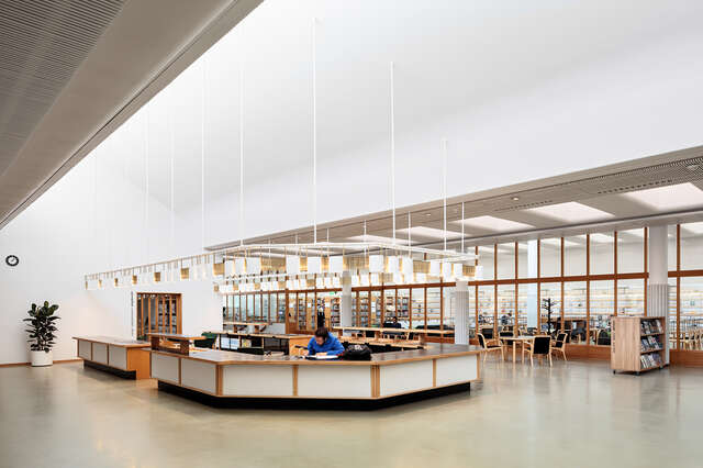 LIbrary information desk in a spacious white room.