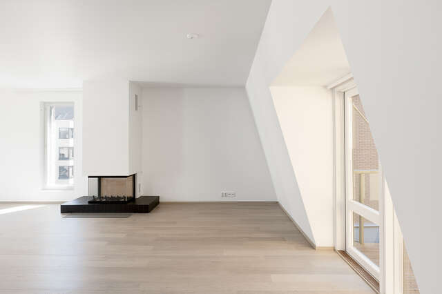 White minimalistic interior with a fireplace.