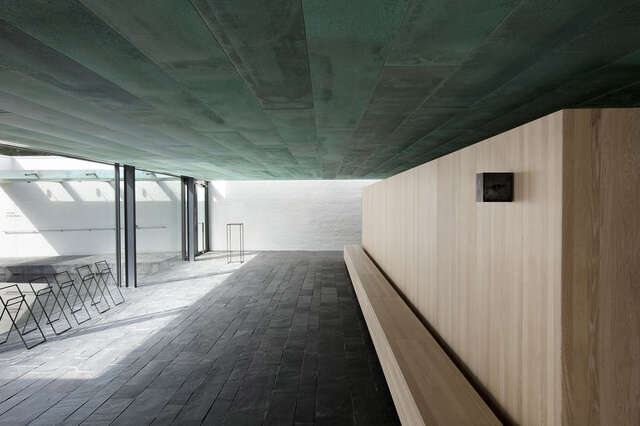 Interior of a funerary chape, wooden bench and stools
