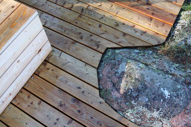 A wooden floor and a large stone.