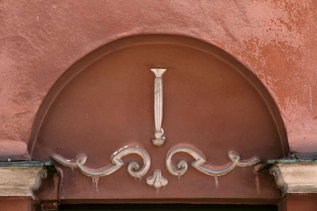White decorative figures on a wall.
