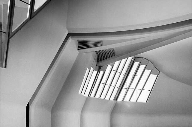 Slanted window panels next to the ceiling.