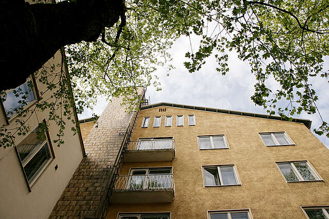 Yellow facade with a protruding fire escape.