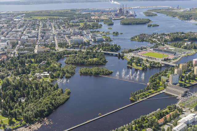 Aerial photo of a city by a river mouth, see further away