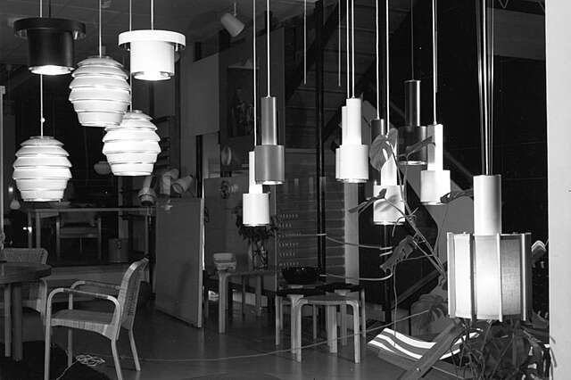 Dark interior with hanging ceiling lights designed by Aalto in the foreground.