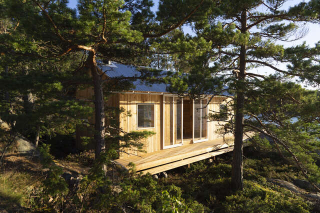 A small wooden cabin structure surrounded by trees