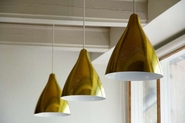 Gold colored ceiling lamps with small holes in them