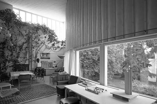 The principal space in the building is the curving studio which has a view opening onto the courtyard. Horizontal battens fixed to the high walls of the studio allowed drawings to be displayed there. The rear wall is covered with climbing plants reaching up to the high-level windows and prototypes of light fittings designed by Alvar Aalto are hung in front of the wall.