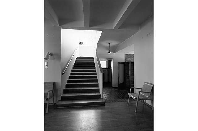 Black and white picture if a wooden staircase.