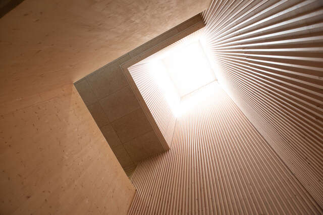 View of a skylight shining light into a wooden structure