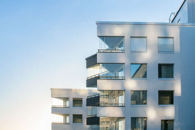 White plastered building facade with sharp corners.