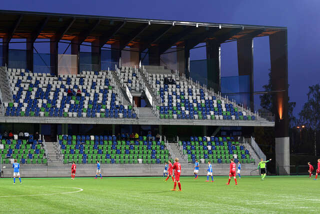 Sports arena and spectator stands from an angle during a game.
