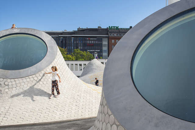 A girl walks on a dome of the museum on Lasipalatsi Square.