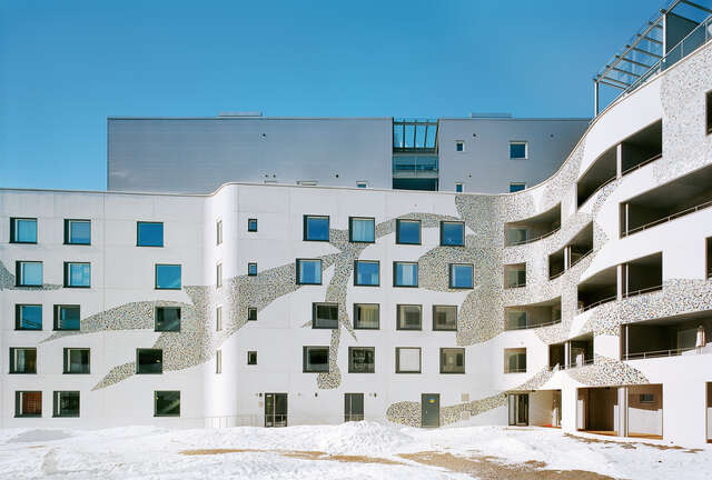 Curvy white facade with mosaic flower details