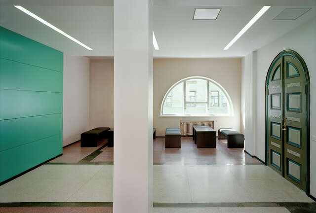 Arch door and window in a room with soft benches and sofa tables