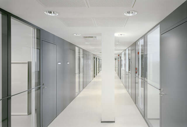 Corridor with grey and glass walls.