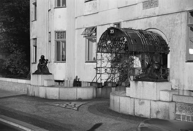Metal arch structure protruding from the entrance door.