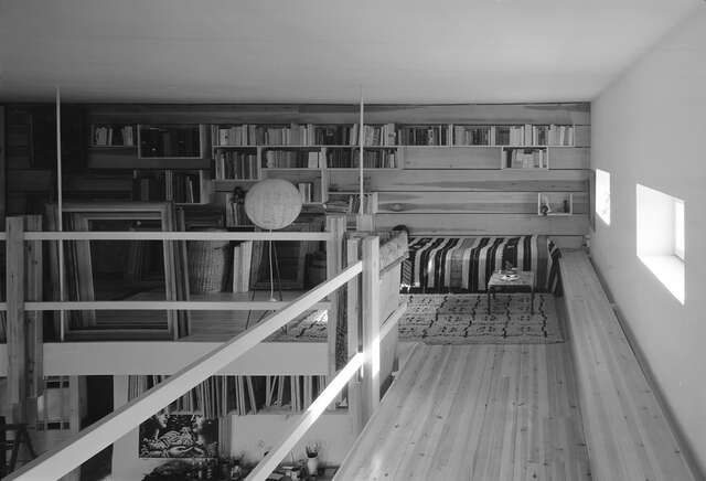 Bed and bookshelves on a loft.