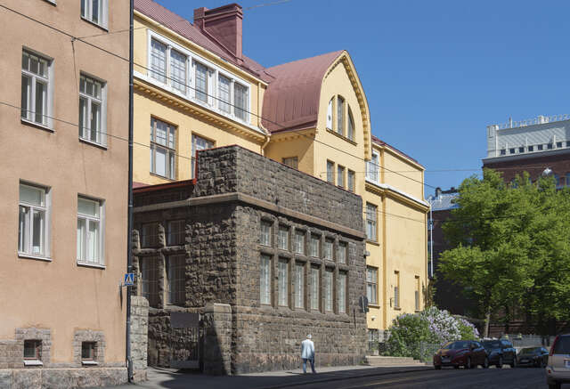 Protruding part of the school building with a stone facade.