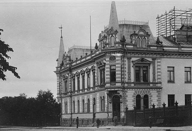 Old picture of the facade with both towers visible.