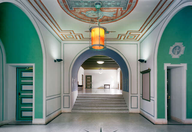 Lobby with elevating stairs, hanging light and ceiling frescoes