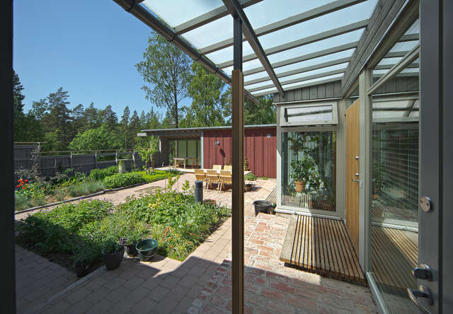 View under a terrace canopy looking over a garden