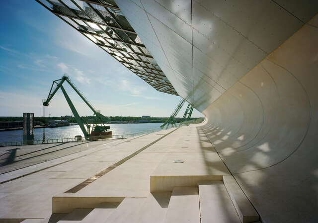 Curved wall extending towards the ocean.