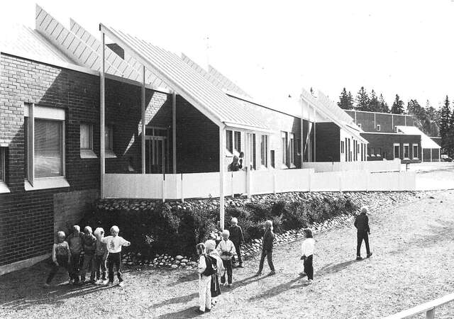 View of the elevation on the yard side, children playing in the yard
