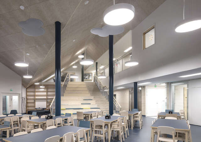 Interior space, high folded ceiling, tables and chair