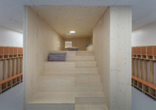 Wooden box with stairs inside, in a corridor