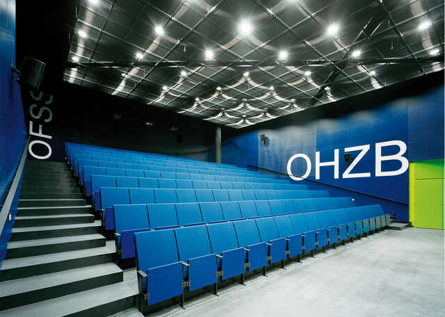 Auditorium with blue seats.