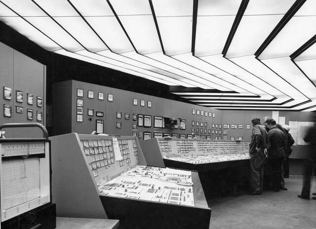 Control room with multiple electronic displays and control panels