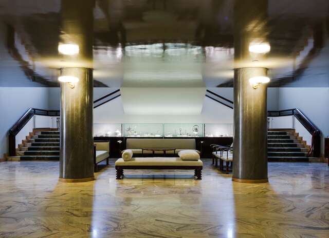 Fancy interior with marble floors, black marble pillars and gold decorative elements.