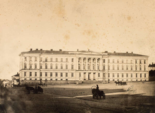 Helsinki University in the 1860s at the west side of the senate square with its original windows. At the front there are coach drivers.