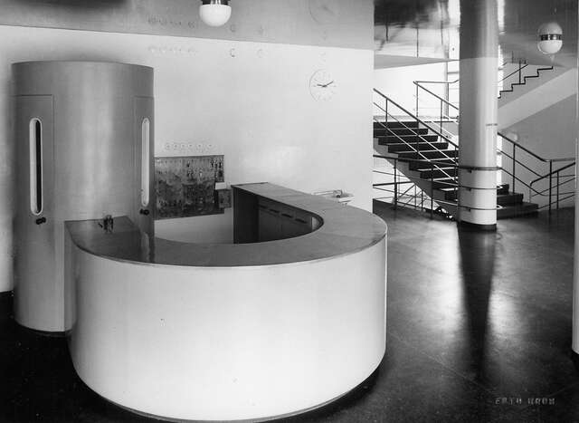 Room with white furniture and a dark floor.