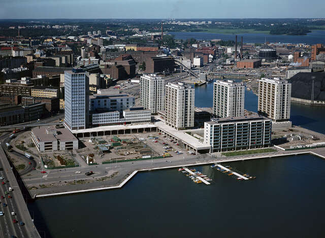 Group of high-rise residential buildings bordered by a sea and urban area