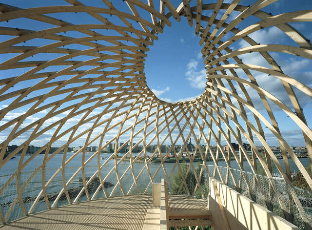 Wood sculptural observation tower with a grid detail shows off the beautiful seaside view.