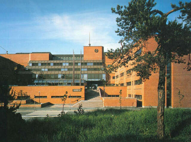 Large red-brick office building on the opposite side of the road