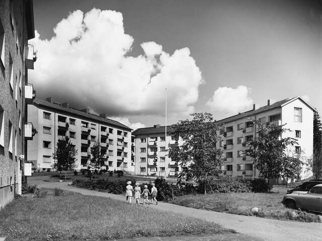 Lamel houses and the green yard, children walking