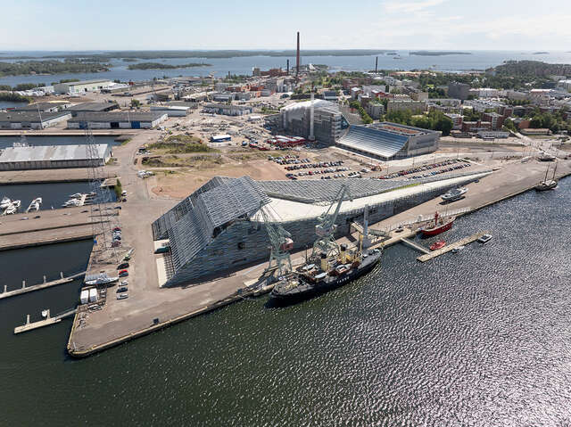 Aerial view of the harbour area, a strangely-formed building on the shoreline