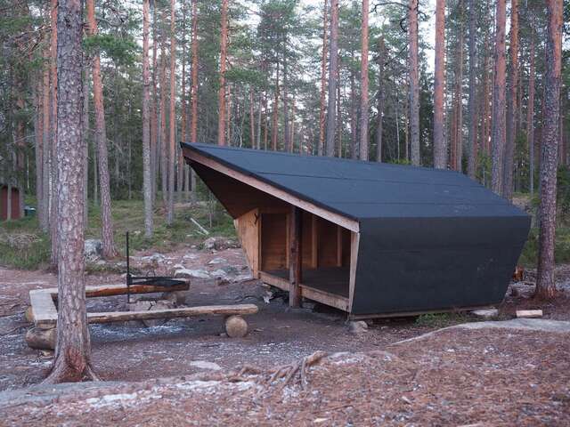 A small wooden structure in a forest