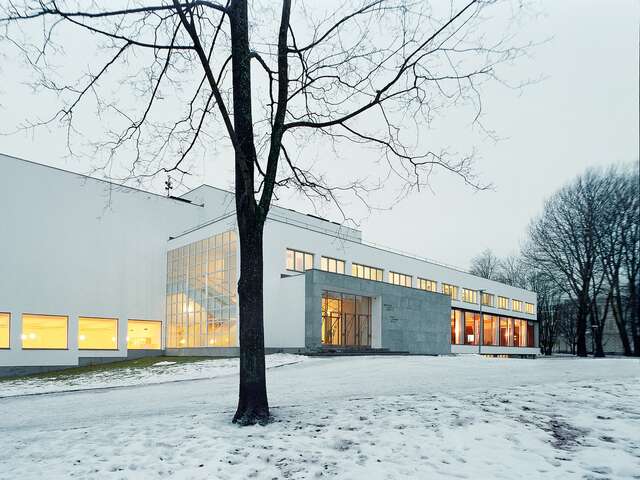 White library building in a snowy landscape.