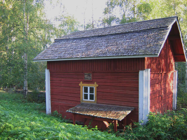 Picture of a wooden cabin painted in red.